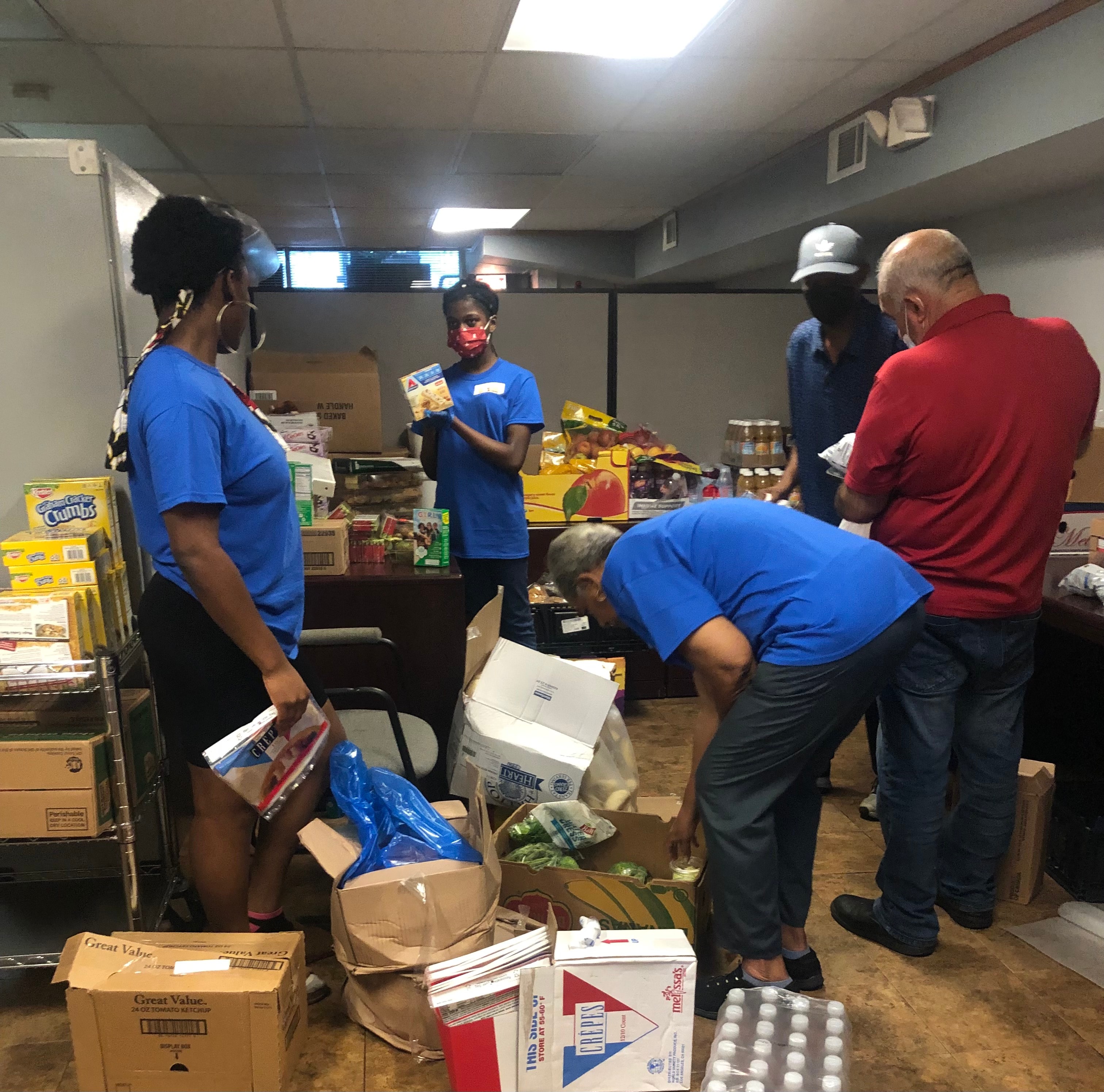 Golden Hope Foundation volunteers sorting and distributing food donations at the food pantry