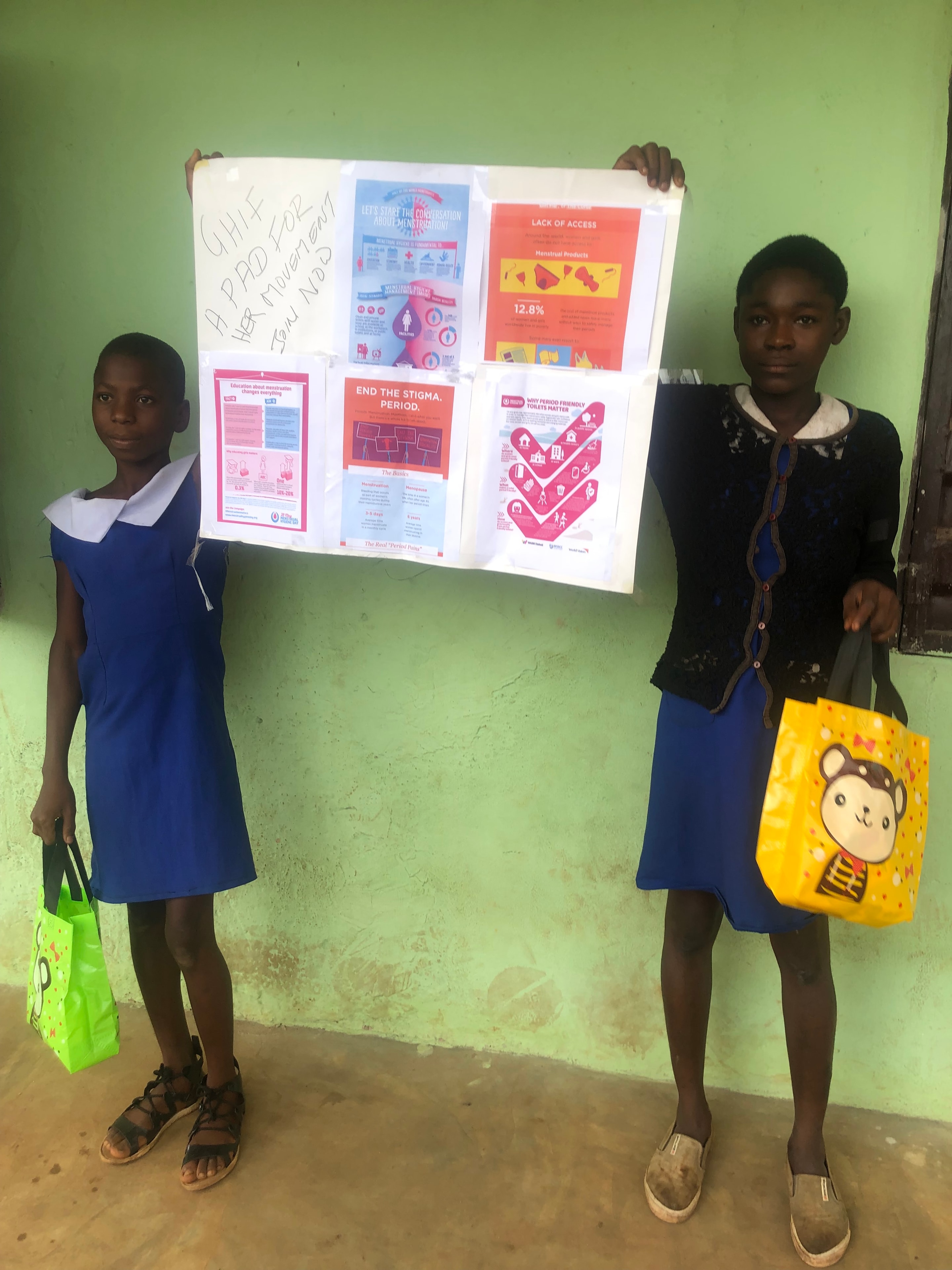 Two girls holding a menstrual hygiene awareness poster — Golden Hope Foundation Global MHM Campaign